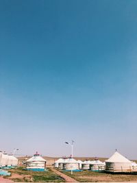 Low angle view of buildings against clear blue sky