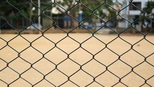 Ground seen through chainlink fence