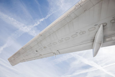 Low angle view of airplane flying against sky