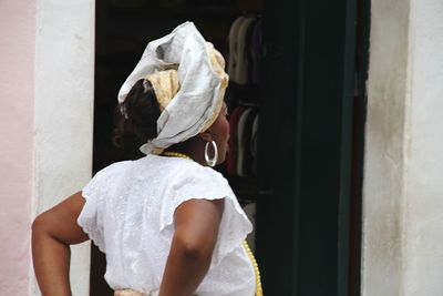 Rear view of woman looking at camera