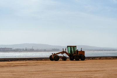 Road grader by the sea, essaouira, morocco.