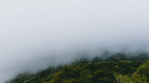 Scenic view of mountains against sky during foggy weather