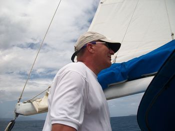 Man in boat on sea against sky