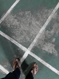 Low section of person standing in water