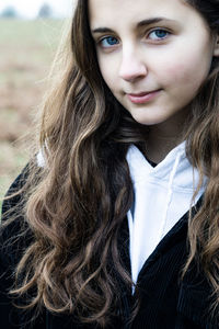 Close-up portrait of teenage girl with long hair