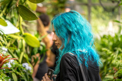 Woman looking at camera while standing outdoors