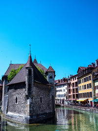 Old buildings against clear blue sky