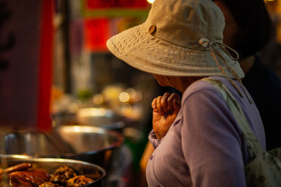 Woman looking at food in market