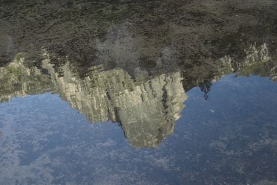 Reflection of rocks in lake water