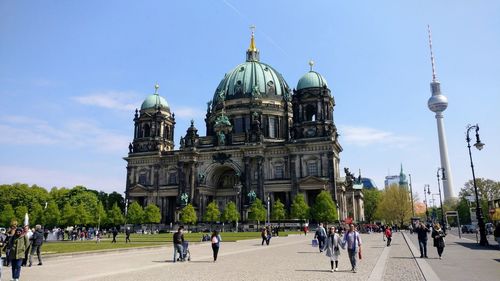 People outside berlin cathedral in city