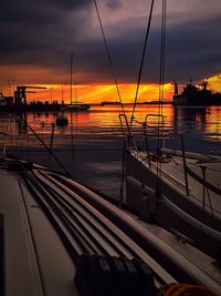 Scenic view of sea against cloudy sky at sunset