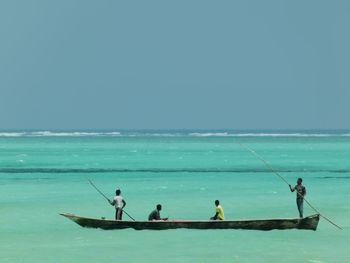 Men on boat sailing in sea