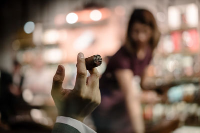 Cropped hand holding cigar