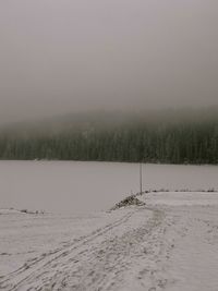 Scenic view of snow covered landscape against sky