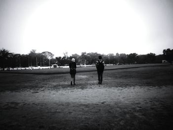 Silhouette of woman on field