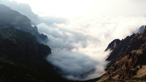 Scenic view of mountains against cloudy sky