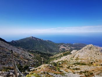 High angle view of mountains against blue sky