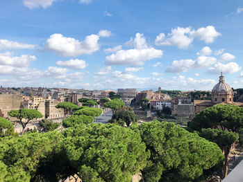 High angle view of trees and buildings against sky