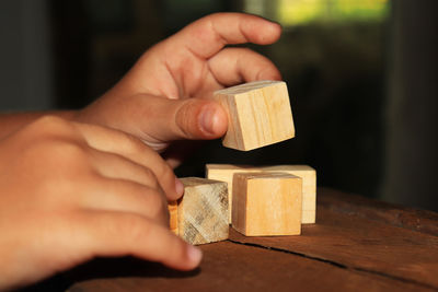 Midsection of person playing with toy on table