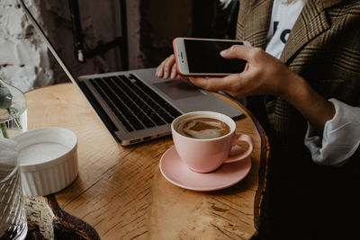 High angle view of man having coffee at table in cafe