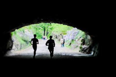 Full length of woman walking in tunnel