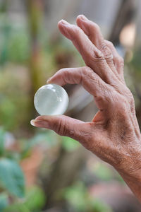 Close-up of hand holding stone