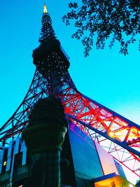 Low angle view of illuminated tower against blue sky