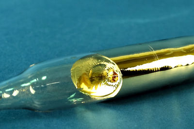 Close-up of illuminated light bulb on table