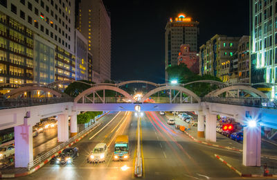 Illuminated city street and buildings at night