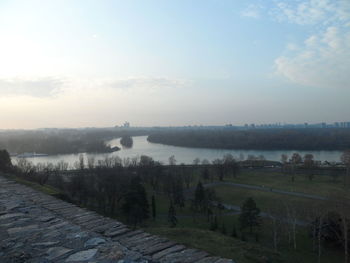 Scenic view of lake against cloudy sky