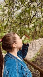 Portrait of woman standing against plants