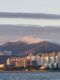 Buildings in city against sky during sunset