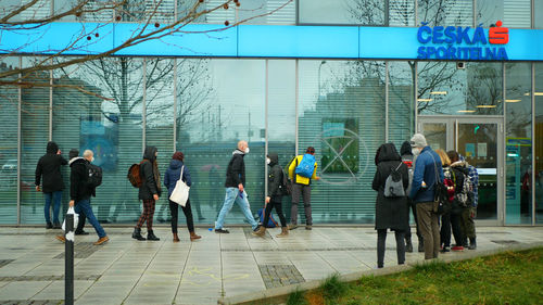 Group of people walking in front of building