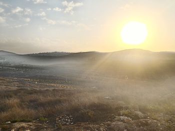 Idyllic view of landscape against sky during sunset