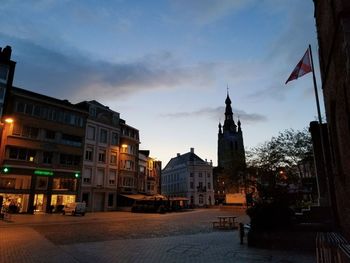 Buildings in city against sky at dusk