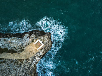 High angle view of water splashing against rock formation