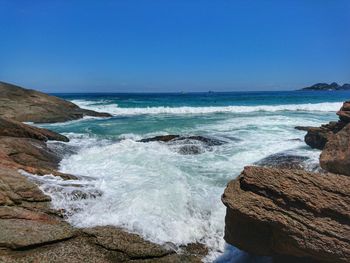 Scenic view of sea against clear blue sky