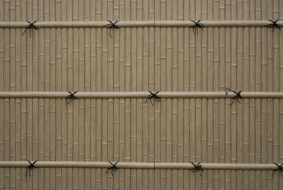 The gray color bamboo wall and pattern of black rope bind on bamboo twig