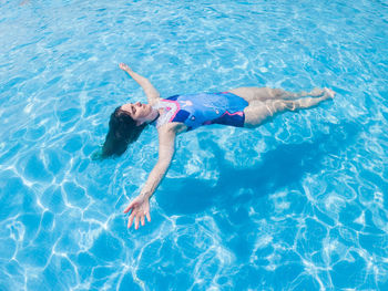 High angle view of woman swimming in pool