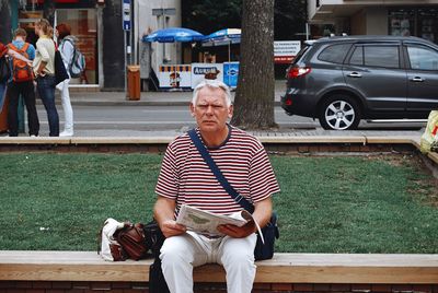 Full length of man sitting on bench