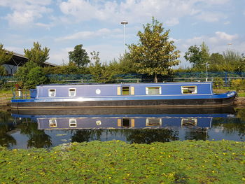 View of swimming pool by lake against sky