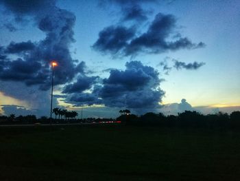 Scenic view of silhouette field against sky during sunset