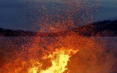 Close-up of big fire against sky at night