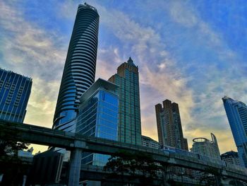 Low angle view of skyscrapers against sky during sunset