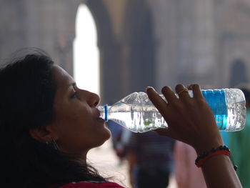 Side view of woman drinking water