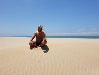 Full length of man on beach against sky