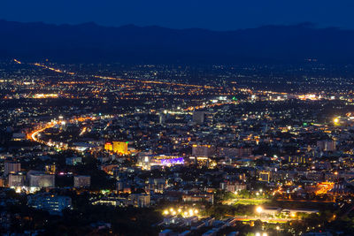 High angle view of illuminated city buildings at night