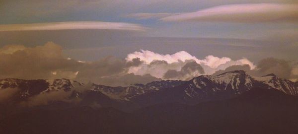 Scenic view of mountains against cloudy sky