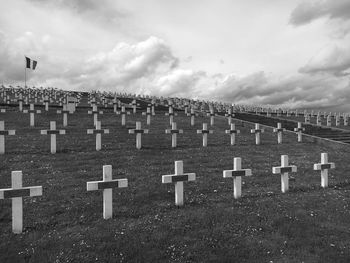 Crosses on field against sky at cemetery