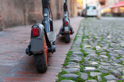 Two electric scooter parked on a footpath in the city center, modena, italy